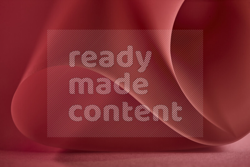 فن تجريدي يعرض منحنيات وتدرجات اللون الأحمر مكونه بضوء ملون