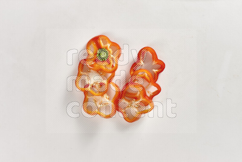 Red bell pepper slices on white background