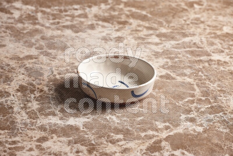 Multicolored Pottery Bowl on Beige Marble Flooring