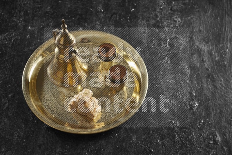 Golash with a drink on a metal tray in a dark setup