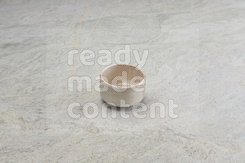 A multicolored pottery bowl on grey marble background