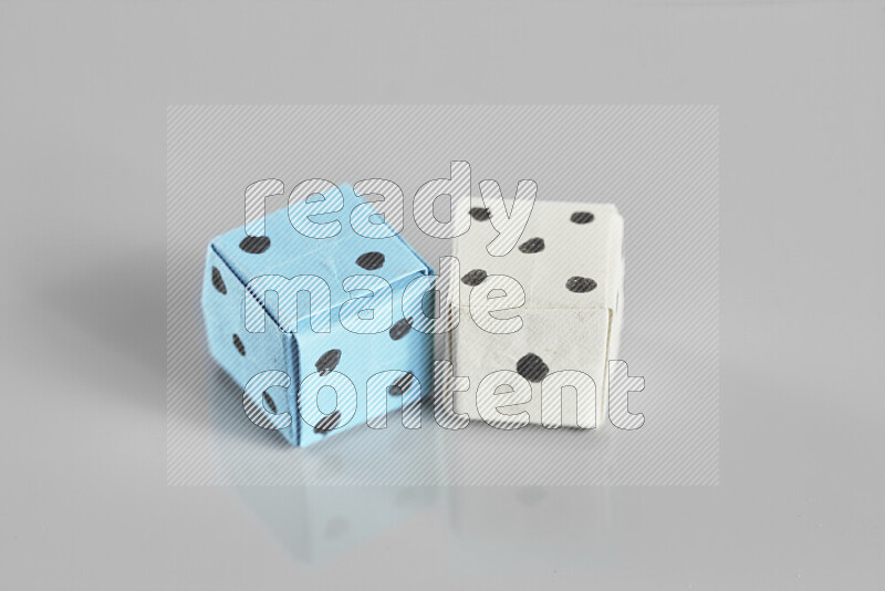 Origami dice on grey background