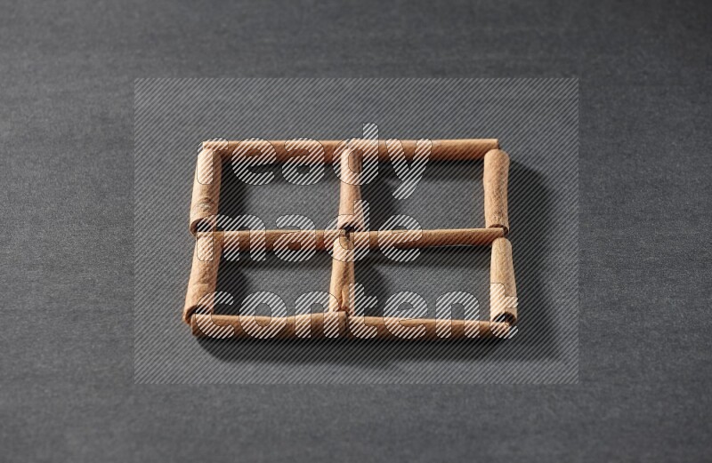 4 squares of cinnamon sticks on black flooring