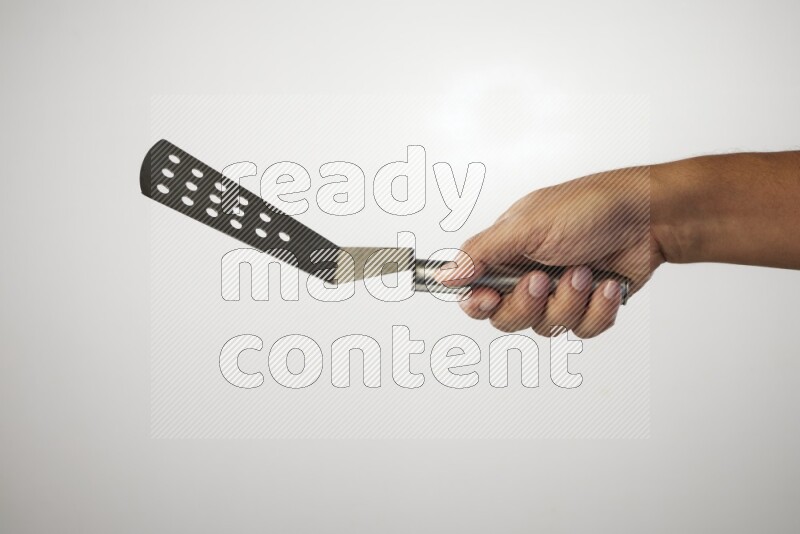 Male Hand Holding Burger Flipper on white background