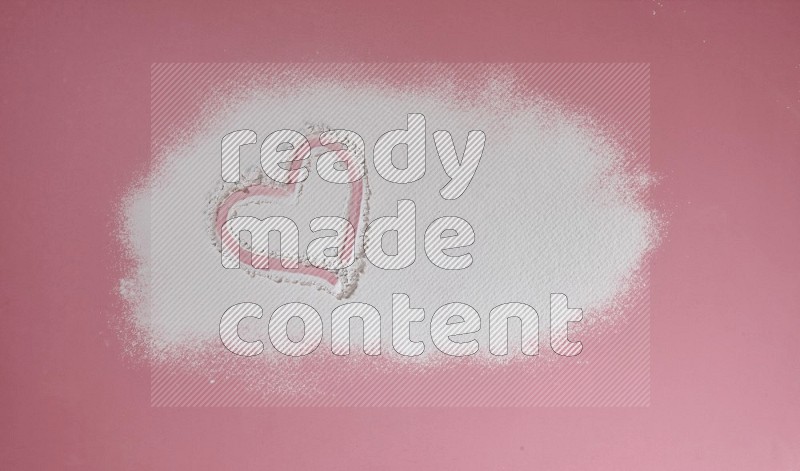 A heart drawn with powder on pink background