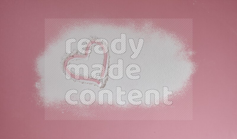 A heart drawn with powder on pink background