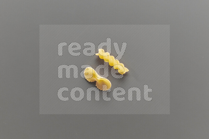 Fiocchi pasta with other types of pasta on grey background