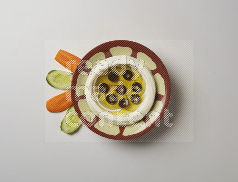 Lebnah garnished with sliced olives in a traditional plate on a white background