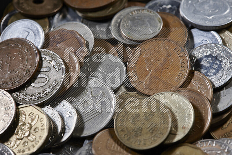 A close-ups of random old coins on black background