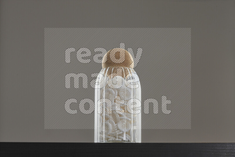 Buttons in a glass jar on black background