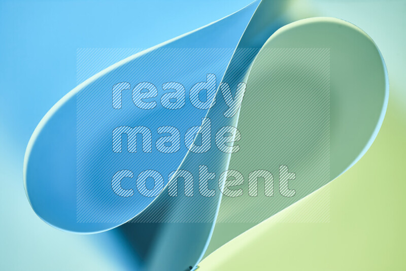 An abstract art of paper folded into smooth curves in green and blue gradients