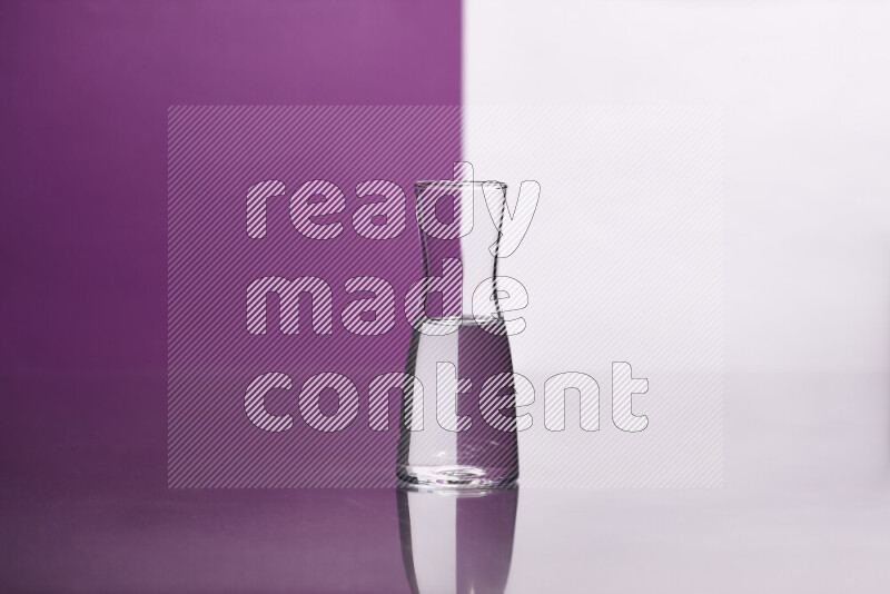 The image features a clear glassware filled with water, set against white and purple background