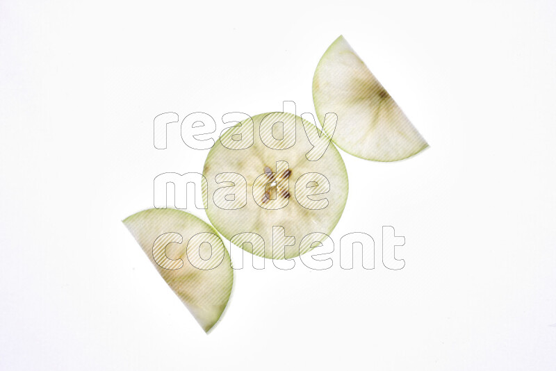 Apple slices on illuminated white background