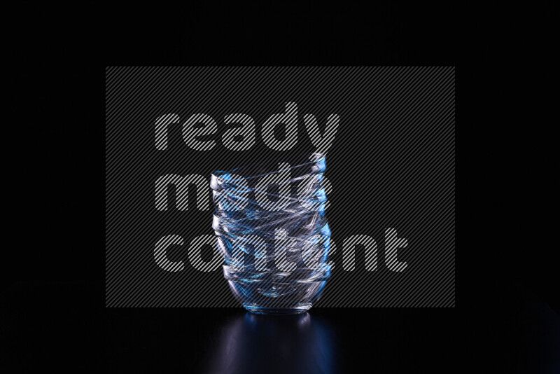 Glassware with rim light in blue and white against black background