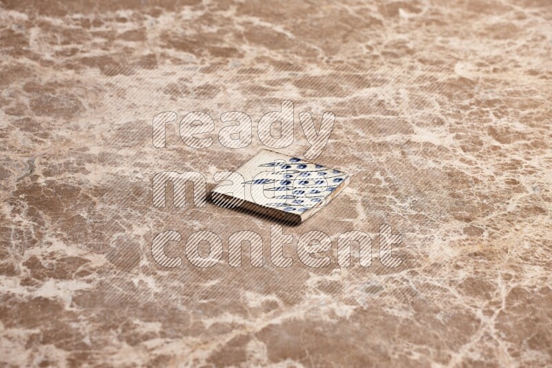 A decorative coaster on beige marble background