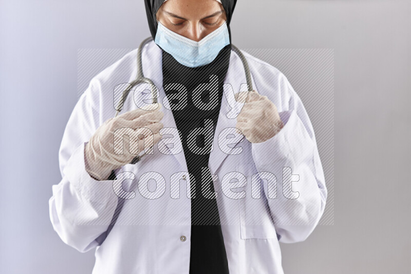 Female doctor wearing an abaya and medical attire in different positions