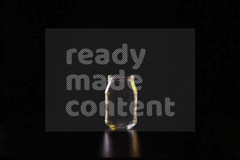 Glassware with rim light in yellow and white against black background