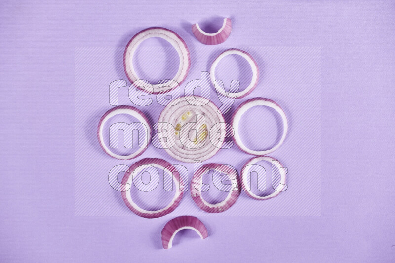 Red onions rings on purple background