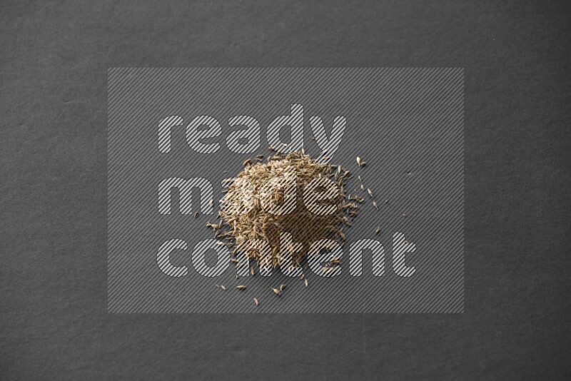 Cumin on a black flooring