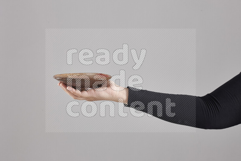 امرأة ترتدي عباءة سوداء تحمل أدوات فخارية مختلفة في أوضاع متعددة