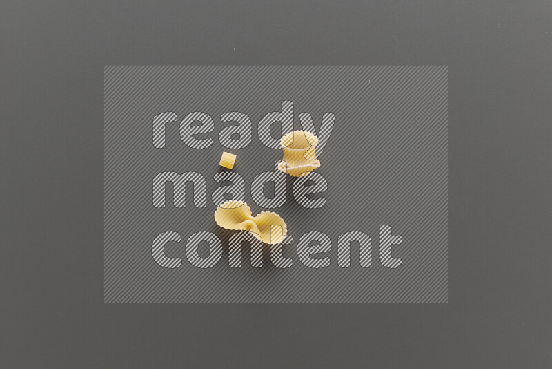 Different pasta types on grey background