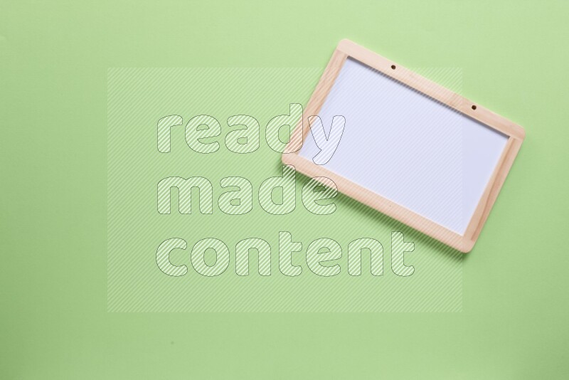 A whiteboard on green background