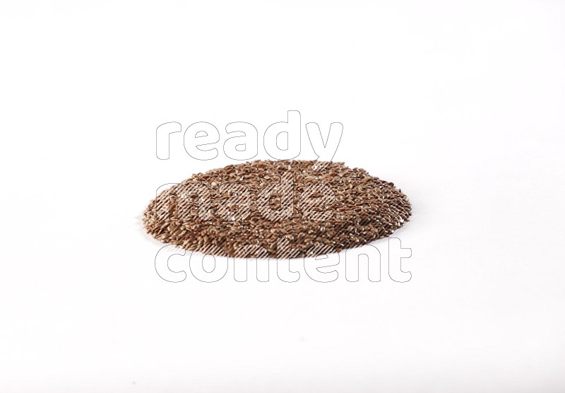 Flax seeds in a circle shape on a white flooring