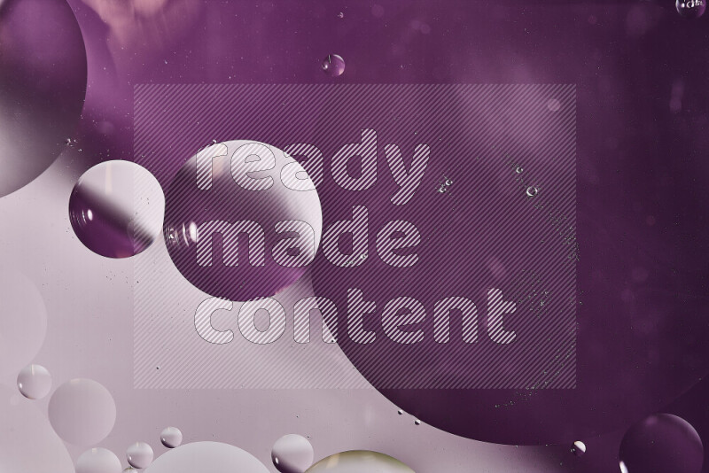 Close-ups of abstract oil bubbles on water surface in shades of white and purple