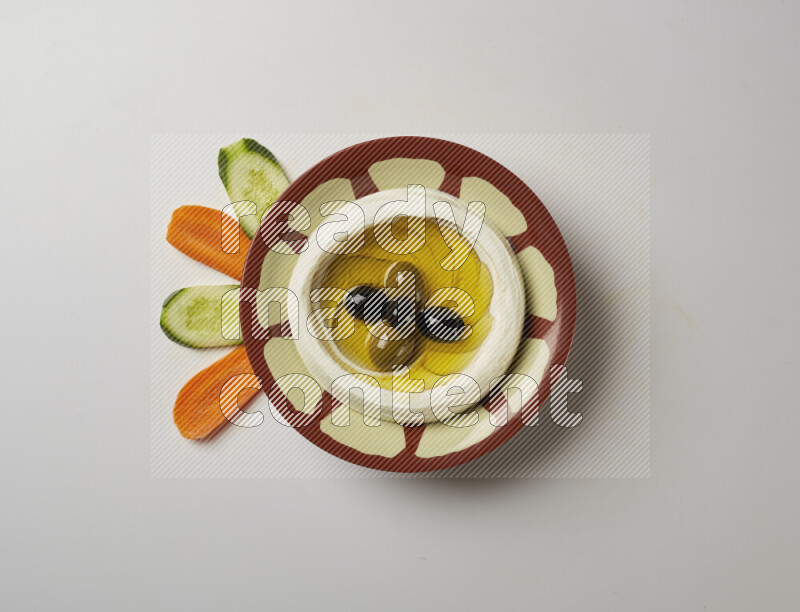 Lebnah garnished with olives in a traditional plate on a white background
