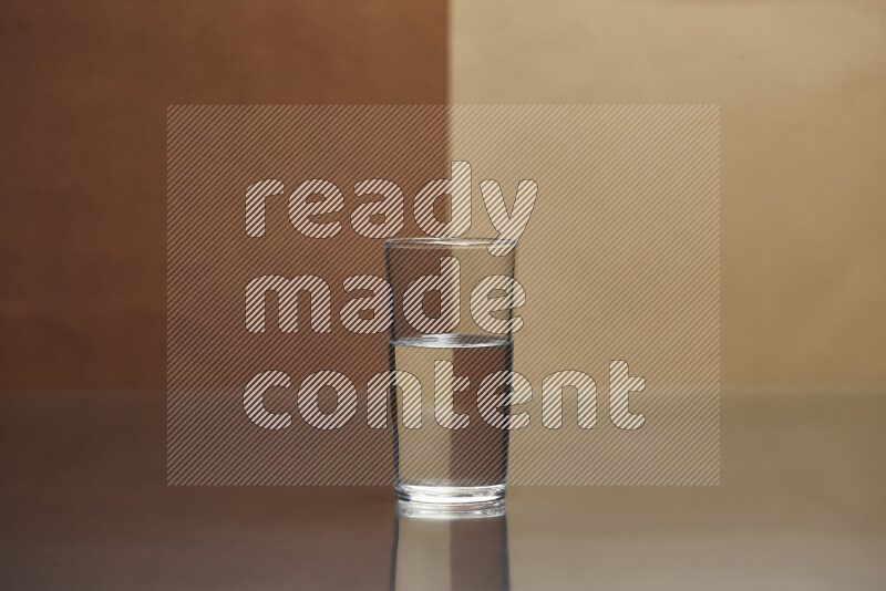 The image features a clear glassware filled with water, set against brown and light brown background