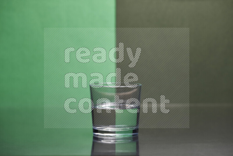 The image features a clear glassware filled with water, set against green and dark green background