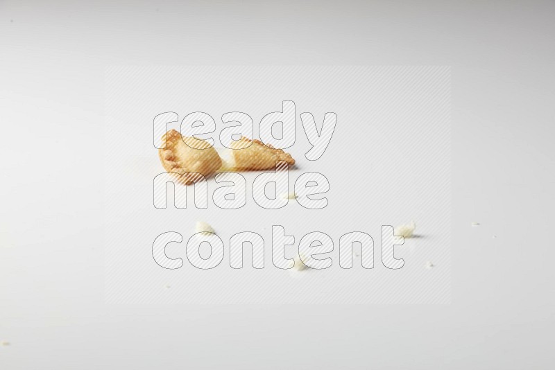One cheese sambosa cut in half on a white background