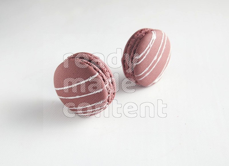 45º Shot of two Red Poppy Flower macarons on white background