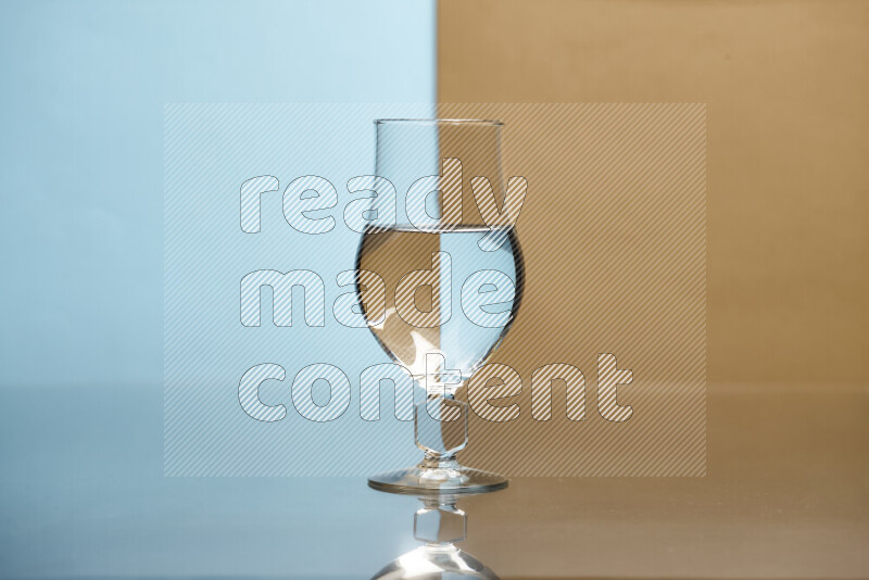 The image features a clear glassware filled with water, set against light blue and beige background