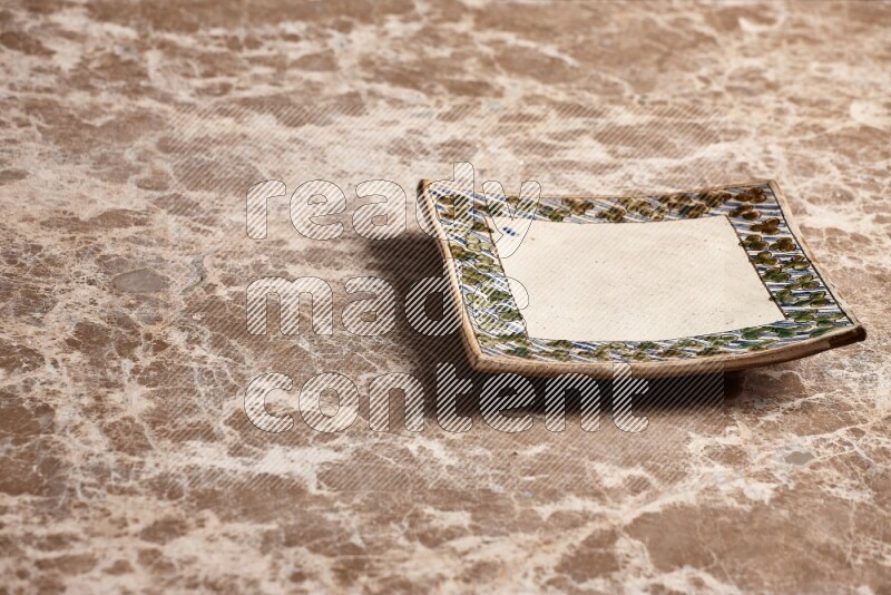 Decorative Pottery Plate on Beige Marble Flooring