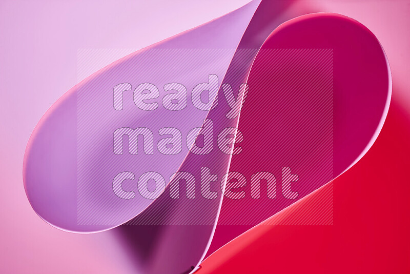An abstract art of paper folded into smooth curves in pink gradients