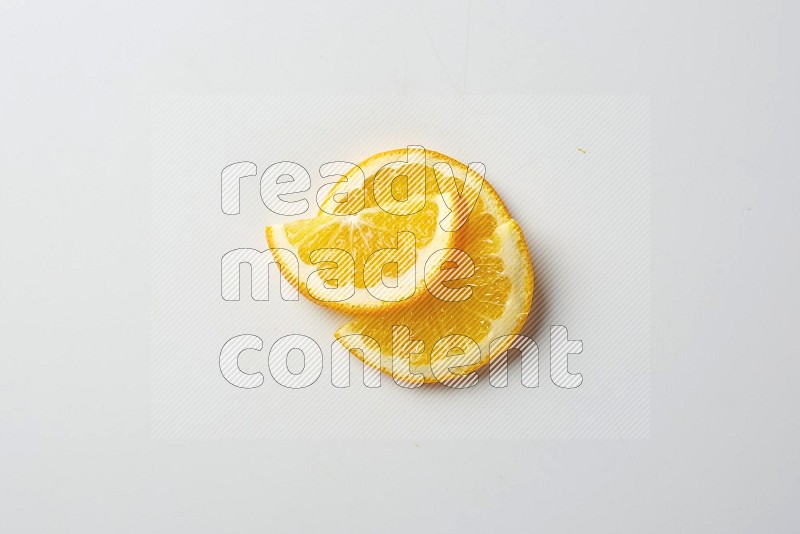 Three halves of an orange slices on white background