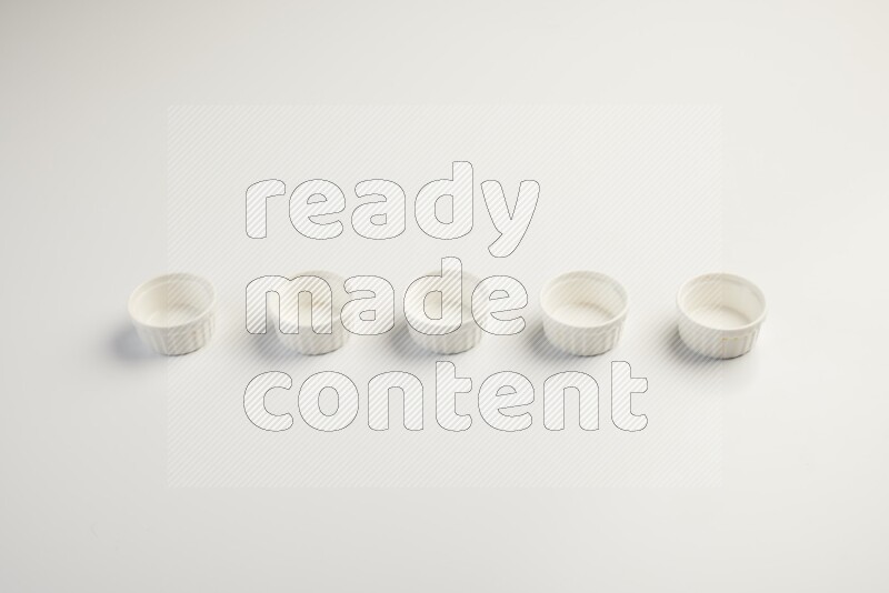 white ceramic round sauce dish on white countertop