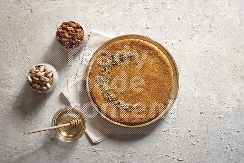 Konafa with nuts and honey in a light setup