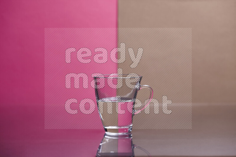 The image features a clear glassware filled with water, set against pink and beige background