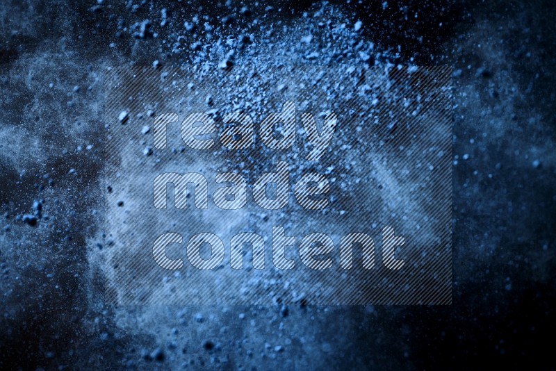 Blue powder explosion on black background