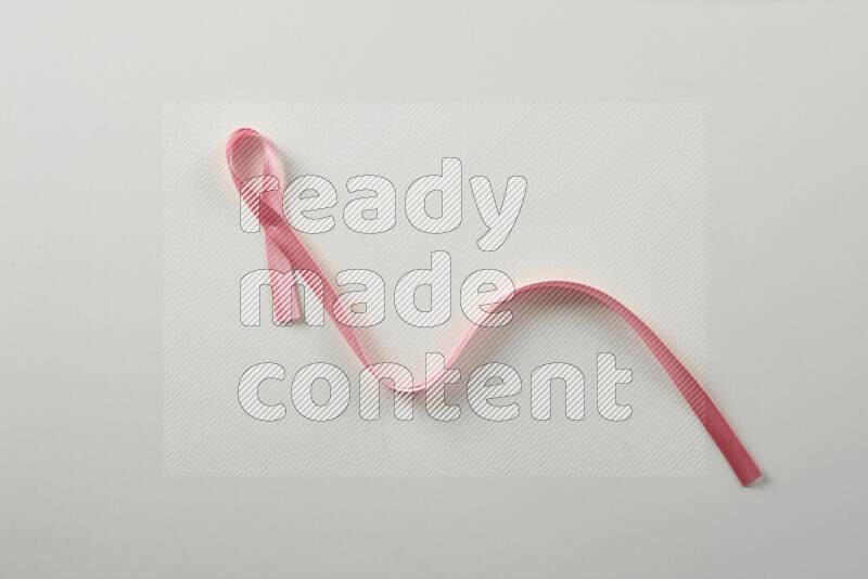 Pink ribbons on white background