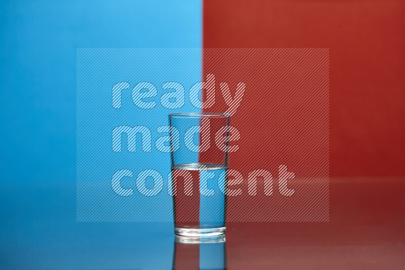 The image features a clear glassware filled with water, set against blue and red background