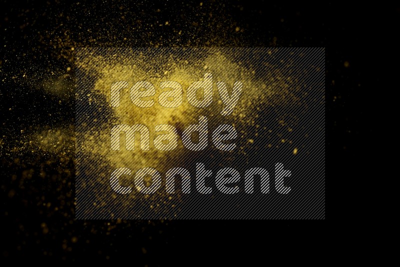 Yellow powder explosion on black background