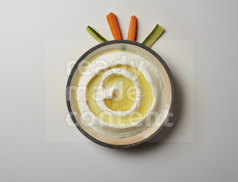 Lebnah garnished with olive oil in a pottery plate on a white background