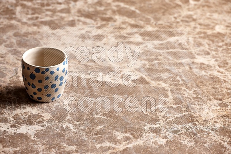 Pottery Cup on Beige Marble Flooring