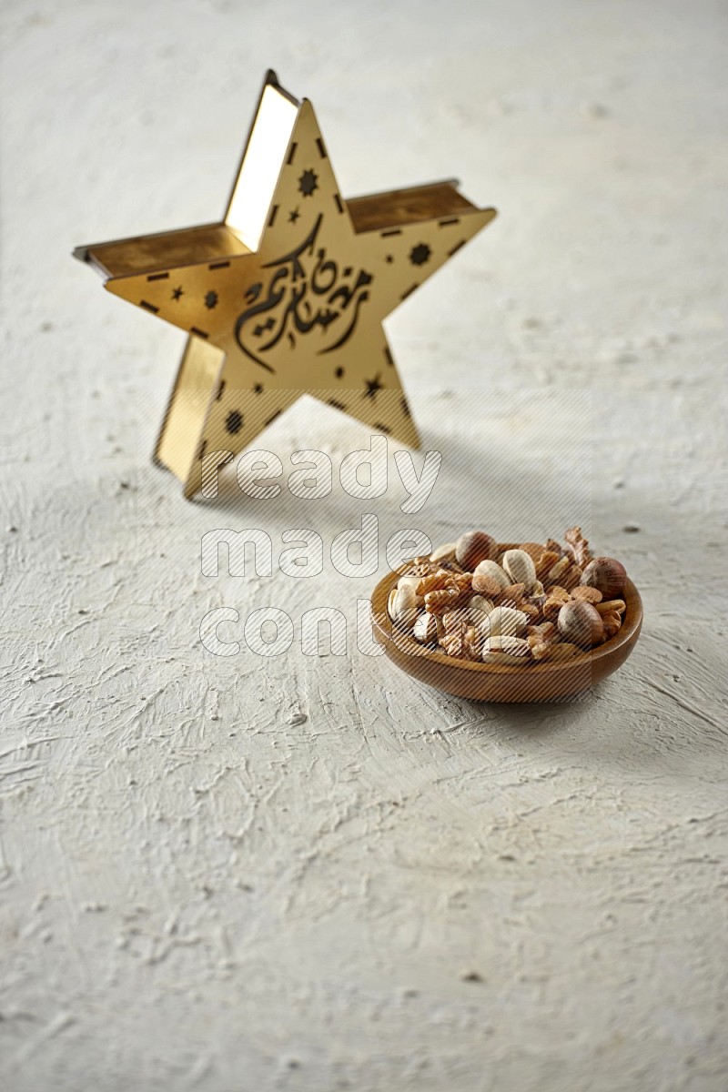 A wooden golden star lantern with different drinks, dates, nuts, prayer beads and quran on textured white background