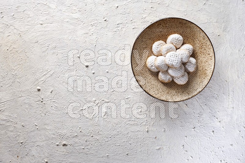 Kahk on a serving plate on a white background