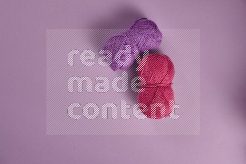 A pink and purple collection of sewing and tailoring tools arranged on a purple background