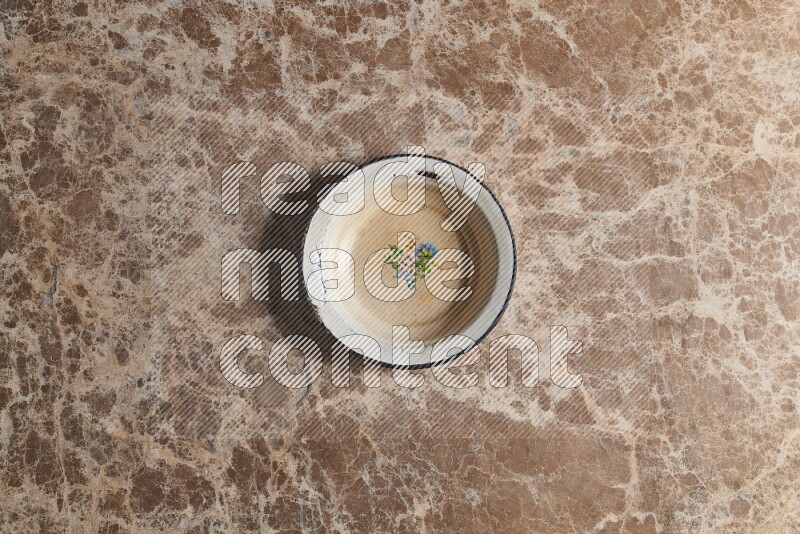 A vintage metal plate on beige marble background